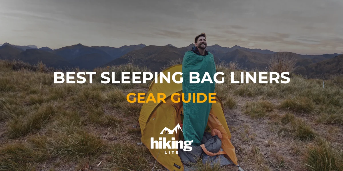 Best Sleeping Bag Liners: A man steps outside his tent, wearing his sleeping bag liner