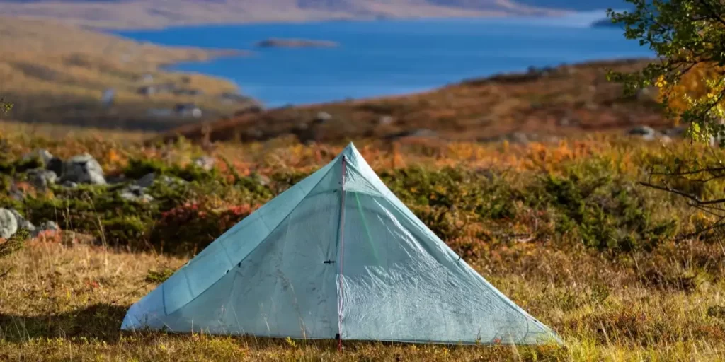 Types of Backpacking Tents: Ultralight Non-Freestanding Tent in Tundra with Scenic Lake Backdrop