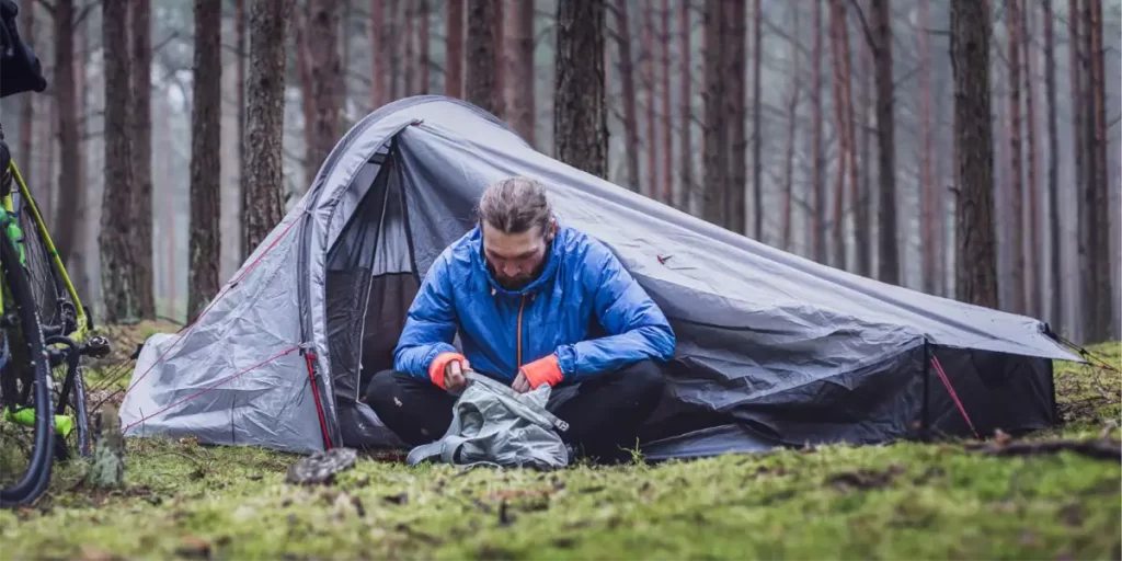 Tent Types: Backpacker with Bicycle and Ultralight Semi-Freestanding Hybrid Tent in Forest