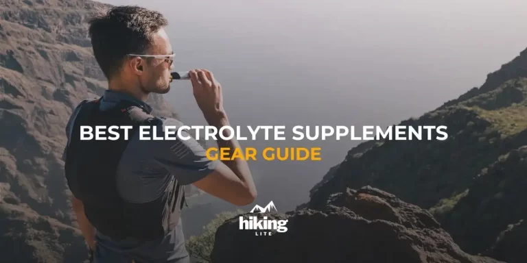 Ultralight backpacker in the mountains taking electrolyte supplements while overlooking the sea