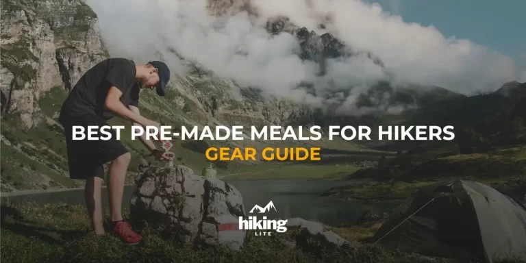 Hiker in the mountains next to his tent pouring water into pre-made meals