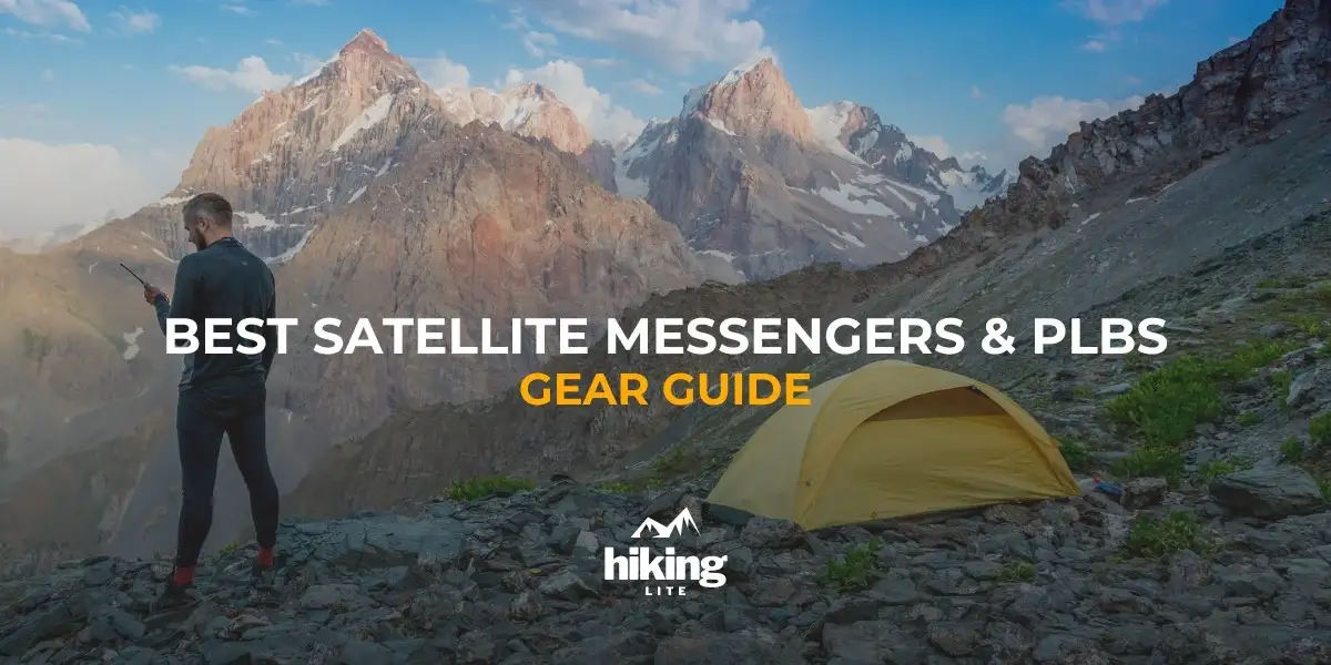 Stay connected and safe with hiking satellite messengers: Hiker in the mountains next to his tent using a hiking satellite messenger