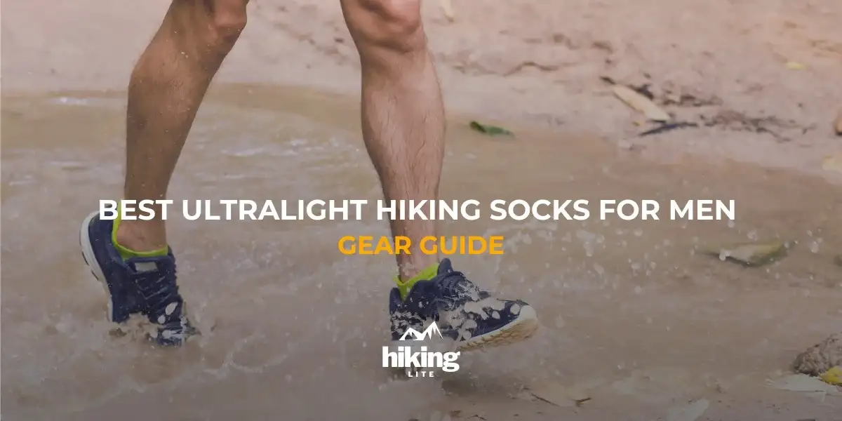 Male hiker in trail runners and hiking socks walking on the beach