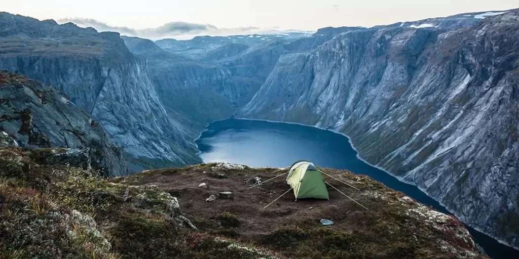 Guy Lines: A tent atop a scenic mountain, securely pitched with guy lines to shield it from strong winds