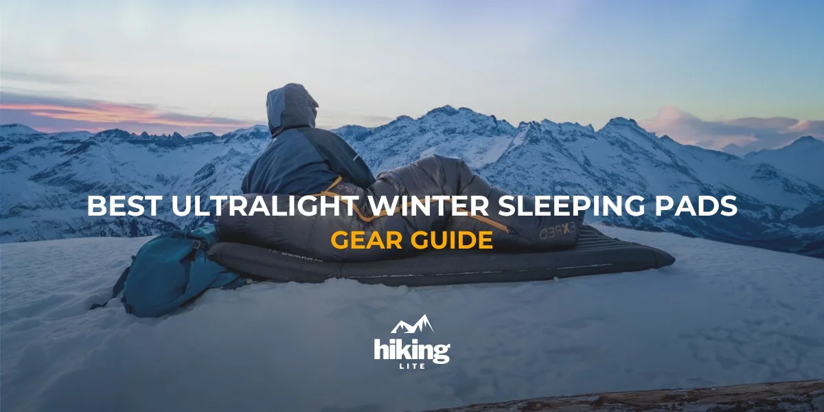 Hiker lying on their winter sleeping pad in the snowy mountains at sunset
