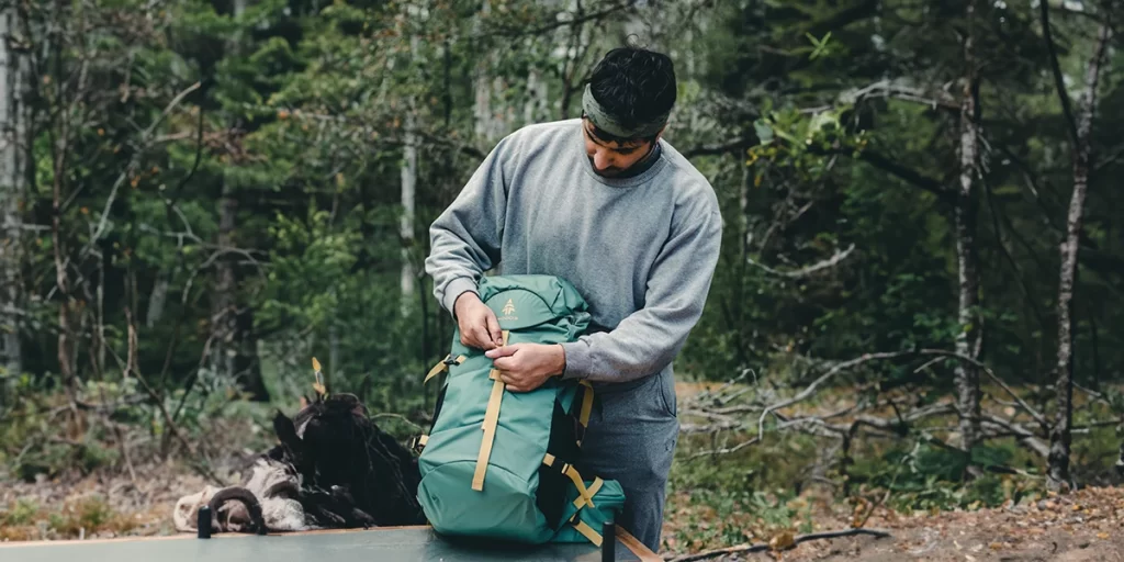 Minimalist Backpacking: A backpacker packing up his 30l backpack before a hike