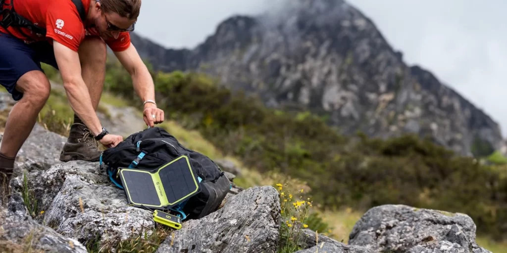 Backpacking Solar Chargers: A man trying to get some sunlight for his solar charger