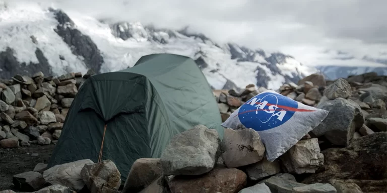 Camping Pillows: A camping pillow next to a tent in snowy mountains