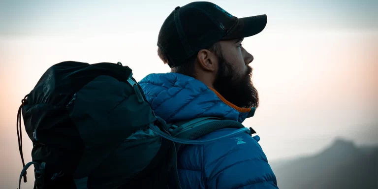 Men's Hiking Jacket: Close-up of a male hiker wearing a down hiking jacket