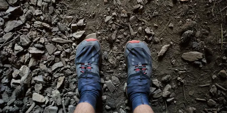 Hiking Gaiters: A close-up of a hiker's feet with trail runners covered by hiking gaiters