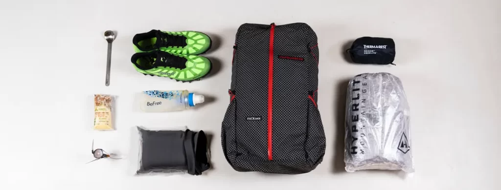 How To Back A Backpack: Backpacking gear neatly laid out on a floor