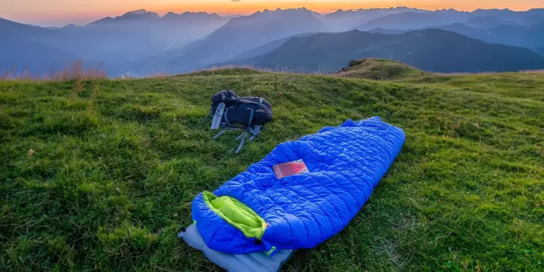 A mummy sleeping bag on a hilltop during the golden hour