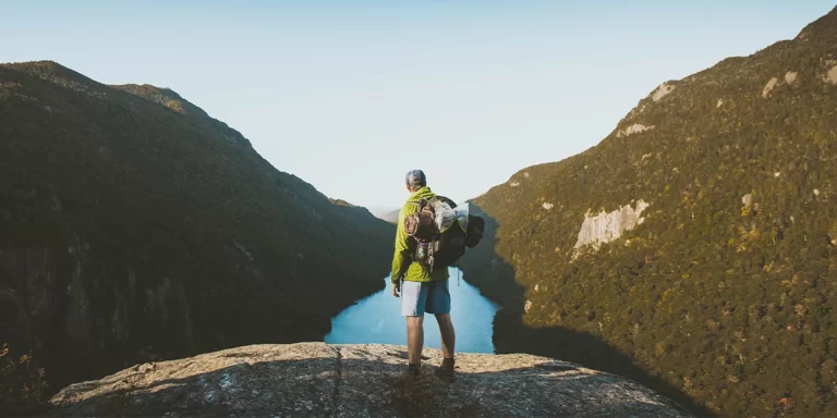 Tents for Tall People: A tall backpacker standing in a mountain valley