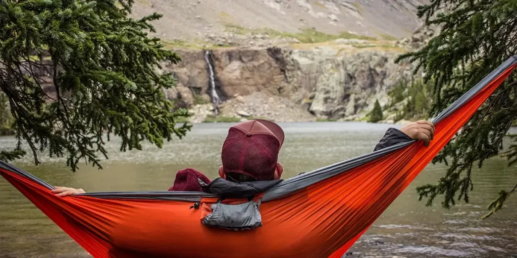 Hammock Camping: A camper enjoying his hammock at a campsite, looking at a scenic gorge