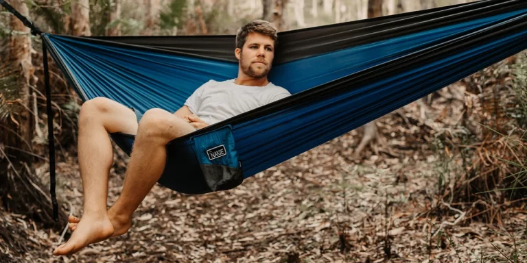 Hammock Camping: A man enjoying his camping experience in a hammock in the forest