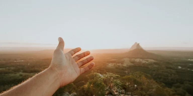 Hiking in Australia: A close-up of an ultralight backpacker's hand showcasing the beauty of the Australian landscape