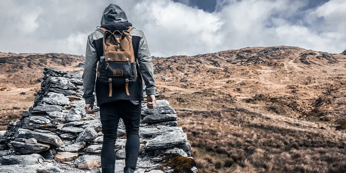 Hiking in Ireland: An ultralight backpacker in a national park climbing rock stairs