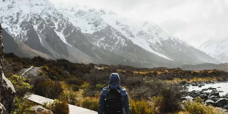 Backpacking in New Zealand: An ultralight backpacker on a well-marked trail between scenic mountains