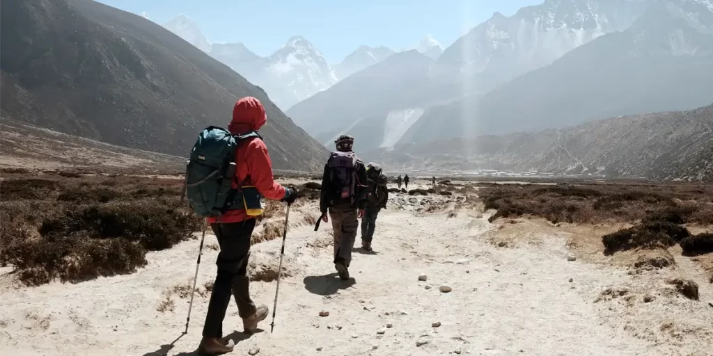 Altitude Sickness: A group of backpackers on a high altitude trail during a sunny day