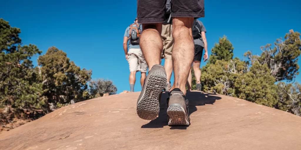 A close-up of hiker's chafed feet while going up a desert trail