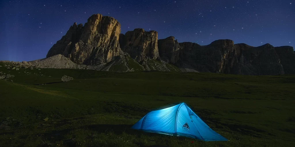 Camping Sleeping Tips: A cozy ultralight single-person tent in the Italian Dolomites during the night