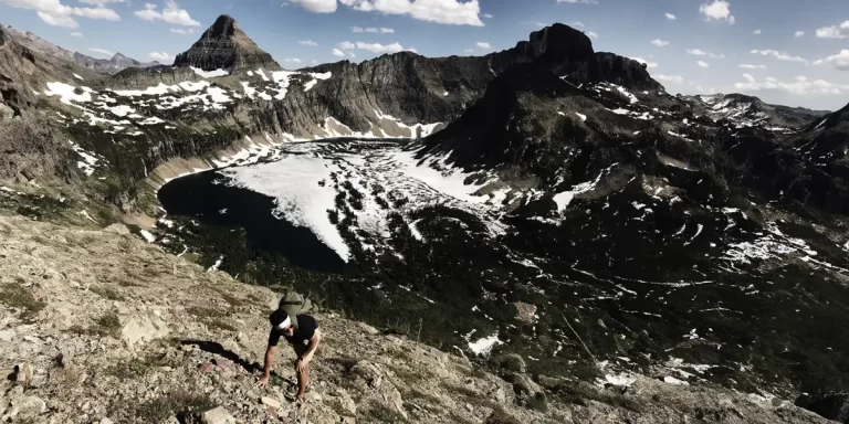 Ultralight Backpacking in Montana: A hiker ascending a steep trail in Glacier National Park