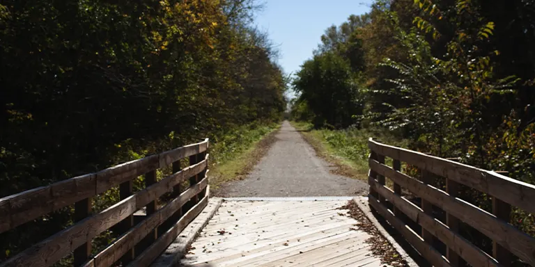 A straight, paved path on a sunny day along the Homestead Trail in Roca, Nebraska