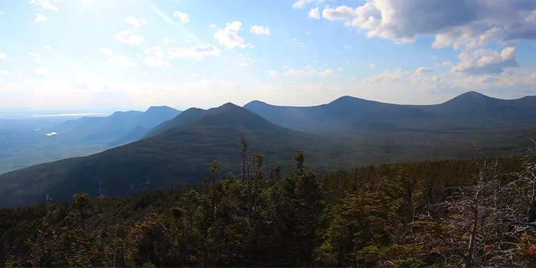 The rocky summit of Owl Mountain in Maine's Baxter State Park offers panoramic eastern views over forests and mountains