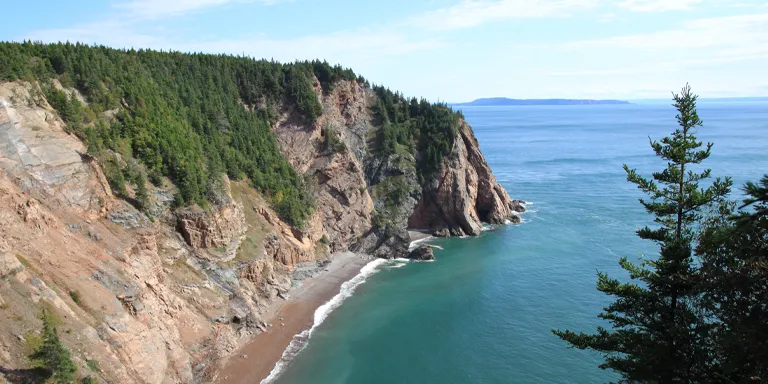 Towering cliffs line the rugged coastal region of Cape Chignecto