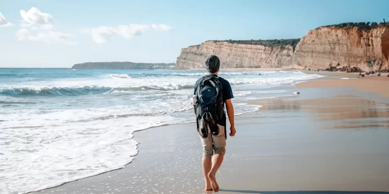 Backpacking in Portugal: A hiker walking on a beach trail