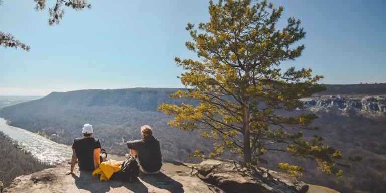 Backpacking in Tennessee: Two hikers enjoying a scenic valley view during a sunny day