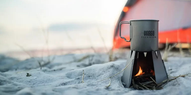 How to Use a Backpacking Wood Stove: Vargo Hexagon Wood Burning Stove for backpacking on a beach next to a tent