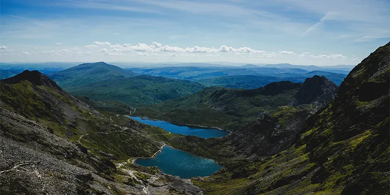 Serene lakes nestled amidst the majestic mountains of Snowdonia National Park, Wales